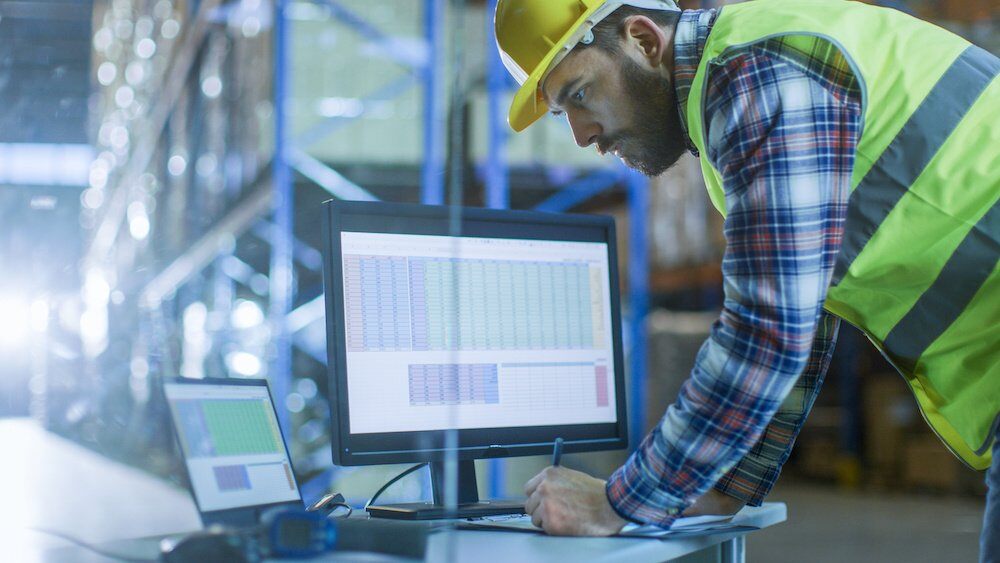 M_W_checking data at workstation in warehouse-small